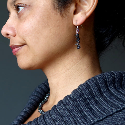 woman wearing hematite earrings and necklace