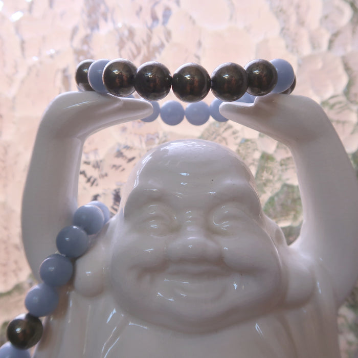 angelite pyrite stretch bracelet on white laughing buddha statue