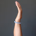 hand wearing blue angelite round beaded stretch bracelet