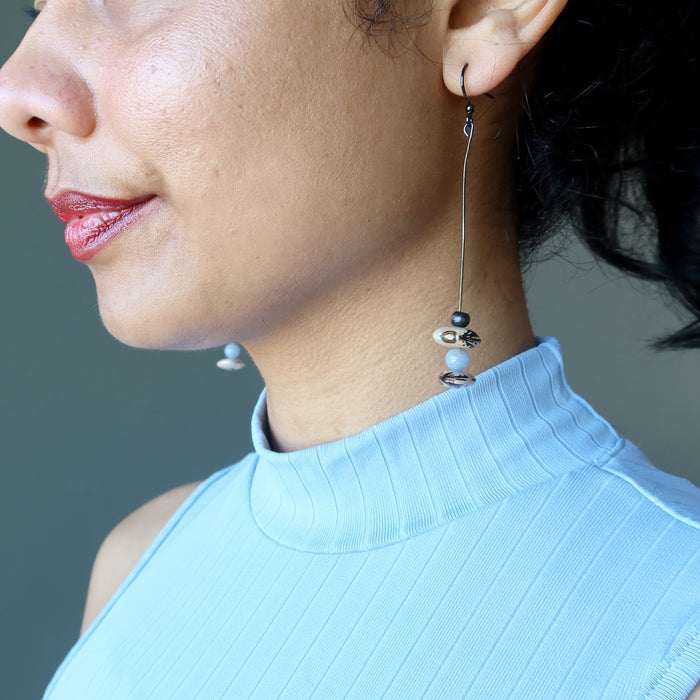 sheila of satin crystal wearing angelite Hopi bean and wood bead dangling earrings