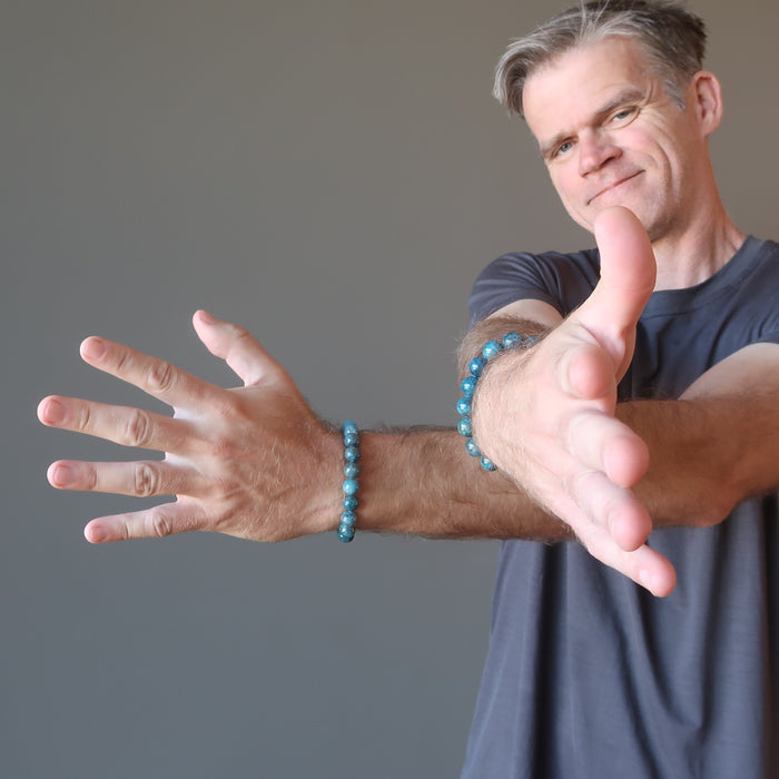 man wearing blue apatite bracelets on each wrist