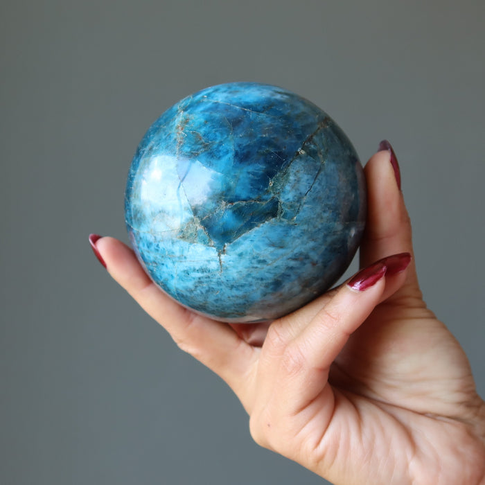 hand holding up an apatite sphere