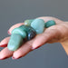 green aventurine tumbled stone set  in palm of hand