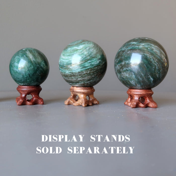 three aventurine spheres on wood display stands which are sold separately
