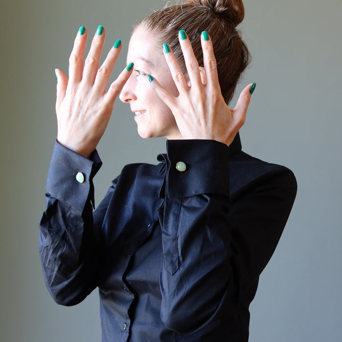 woman in black french cuff shirt wearing green aventurine cufflinks