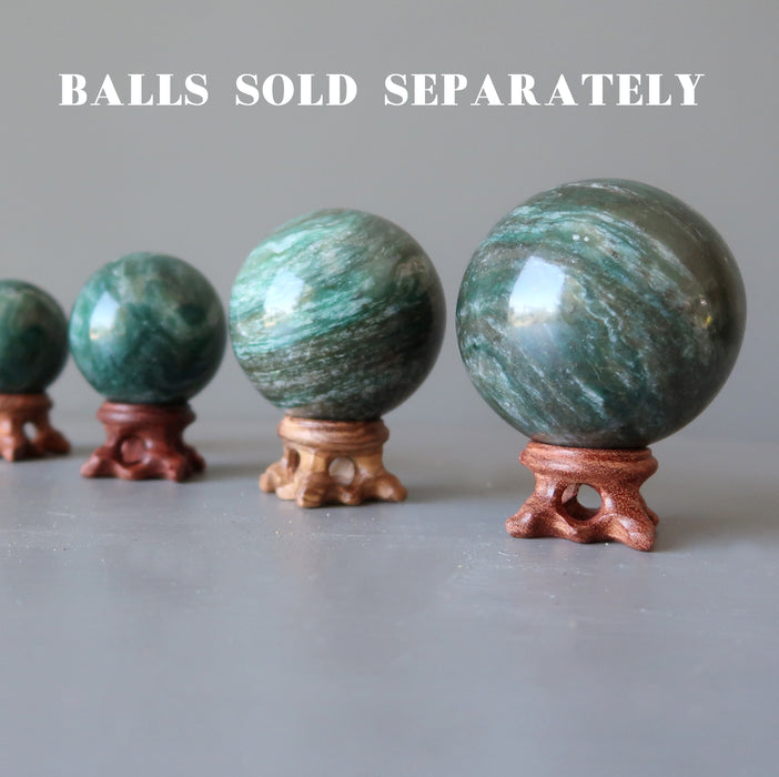 4 green aventurine spheres on set of 4 fancy crystal ball display stands in varying shades of brown wood sold separately