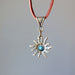 back side of bloodstone sun necklace on leather cord