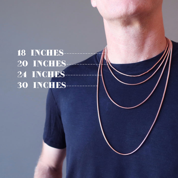 male model wearing 4 different length necklaces