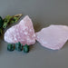 pair of rough pink rose quartz stones with three green aventurine ganesh