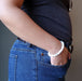 female hand in jeans pocket modeling howlite stretch bracelet