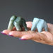 two green jade elephant carvings on palm of hand