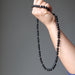 hand holding a black jet stone beaded necklace