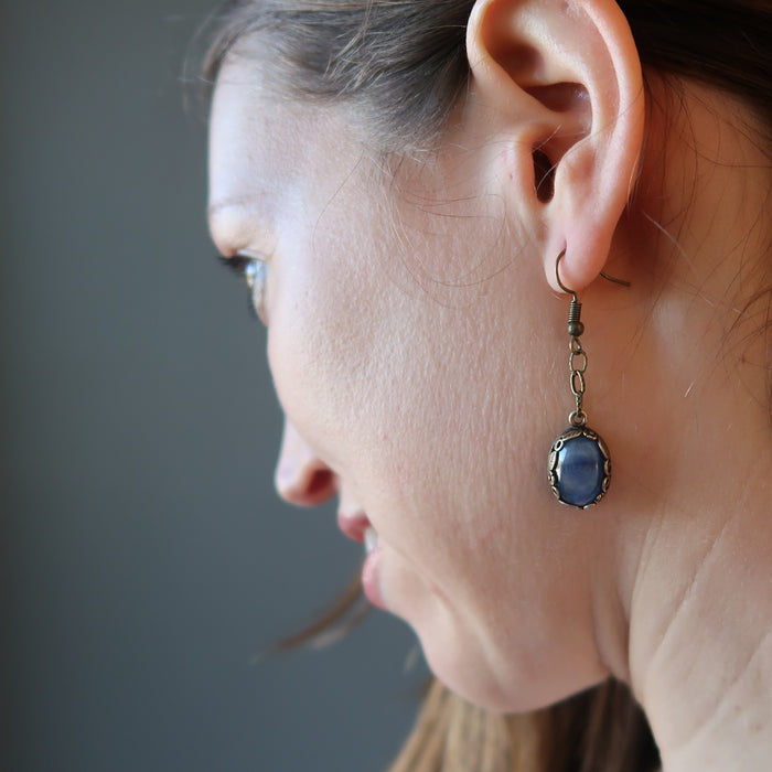 woman wearing blue kyanite dangle earrings