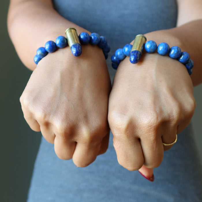 two wrists wearing lapis peace bullet stretch bracelets