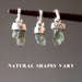 3 moldavite sterling silver pendants on a stick showing natural shapes vary