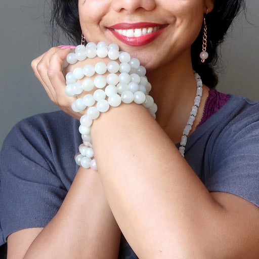 model with a stack of white moonstone bracelets
