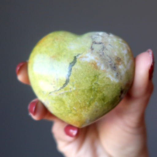 hand holding Green Opal Heart