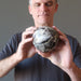 male model holding a Black Opal Sphere
