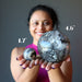 sheila of satin crystals holding two different sizes of Black Opal Spheres