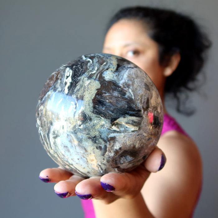 sheila of satin crystals holding a Black Opal Sphere