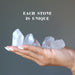 holding 5 raw clear quartz points on the palm each stone is unique