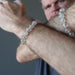ryan of satin crystals wearing rutilated quartz bracelet on each wrist