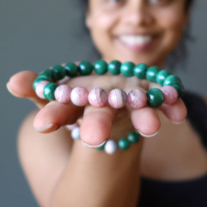 sheila of satin crystals holding a rhodochrosite and malachite stretch bracelet