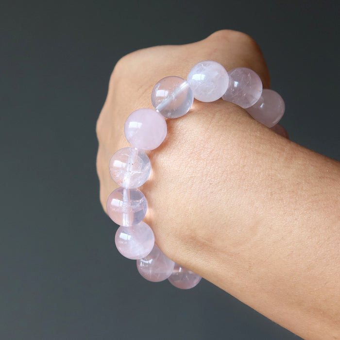 hand wearing clear pink rose quartz round beaded stretch bracelet