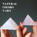 hands holding two pink rose quartz pyramids to show natural colors vary