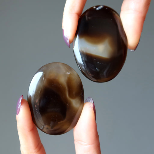 pair of black and brown sardonyx oval stones