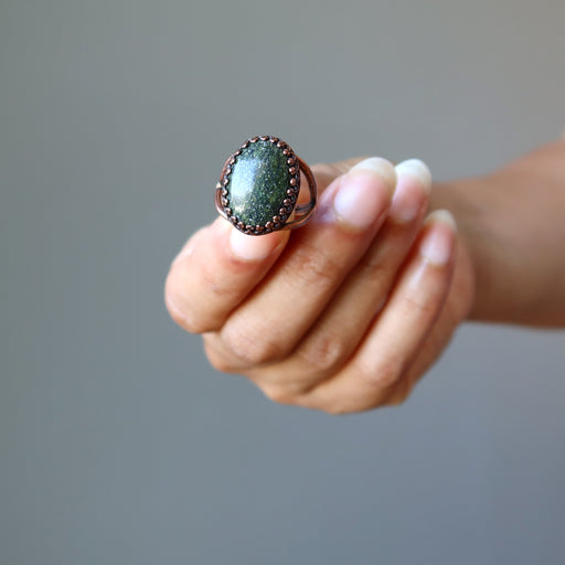 hand holding Adjustable Copper Serpentine Ring
