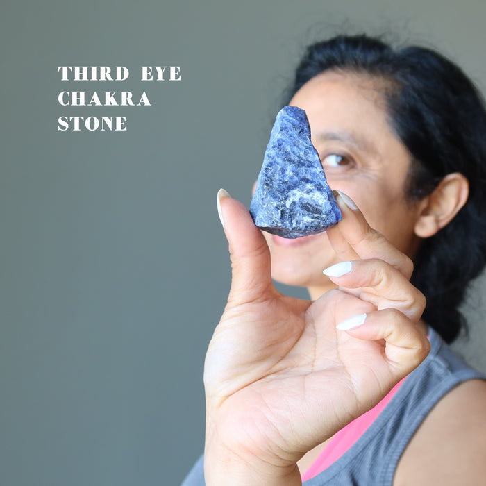 Sheila holding Raw Sodalite Crystal with finger tips