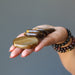 holding 4 tigers eye slabs on the palm