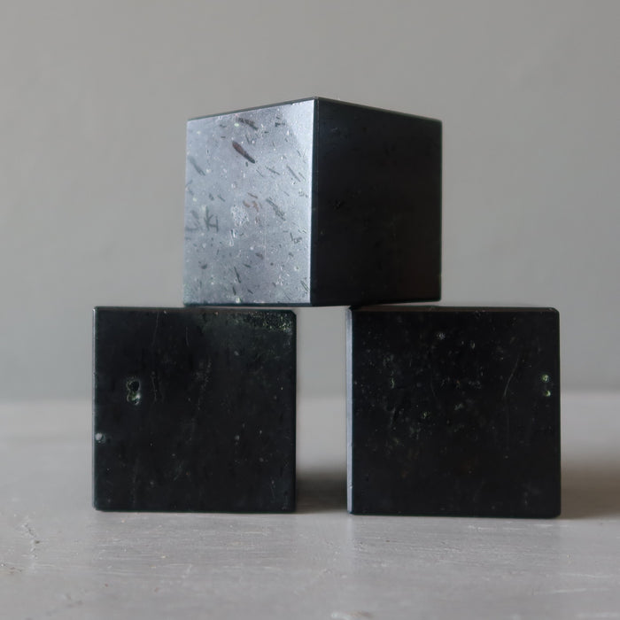 three black tourmaline cubes stacked
