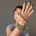 sheila of satin crystals wearing and holding green and brown turquoise jasper round beaded stretch bracelets