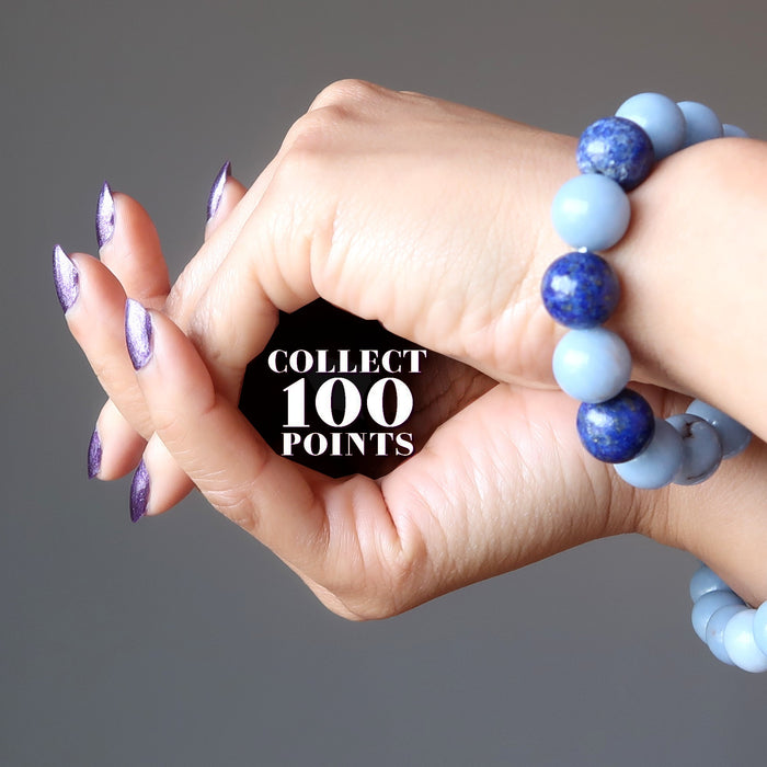 hands wearing blue angelite and lapis bracelets forming a cave with the word collect 100 points written inside