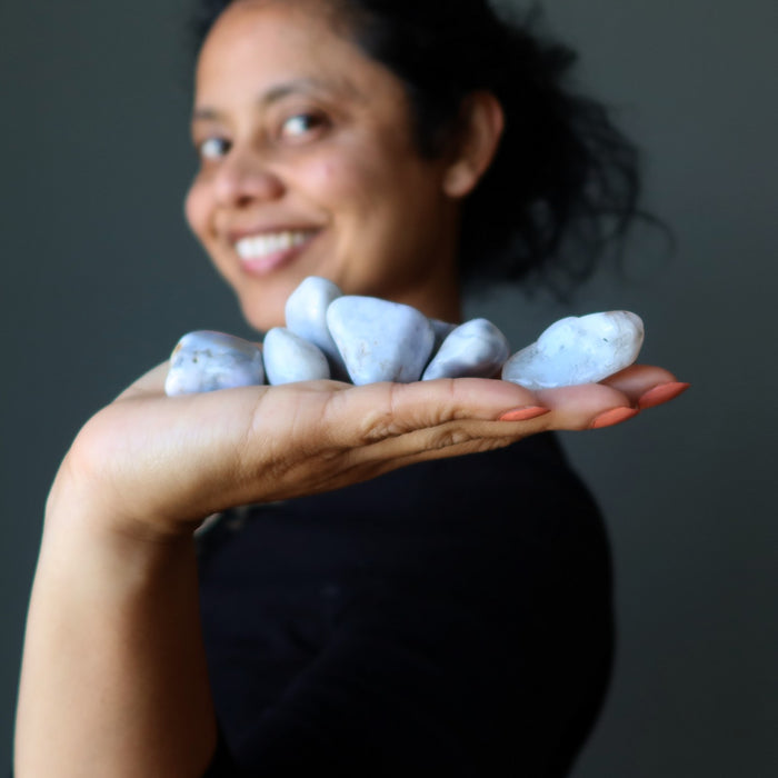 woman holding agate tumbled stones