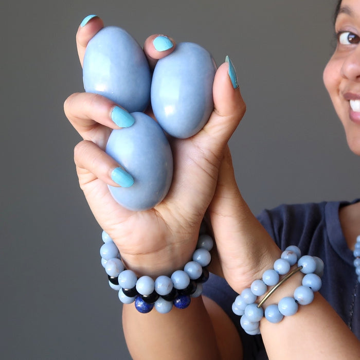 sheila of satin crystals wearing and holding angelite stone