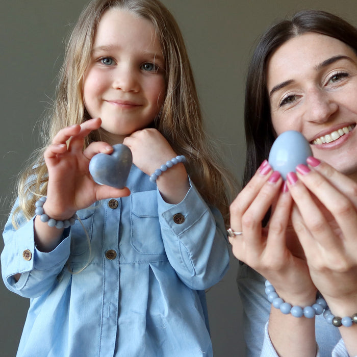 mother and daughter holding angelite crystals