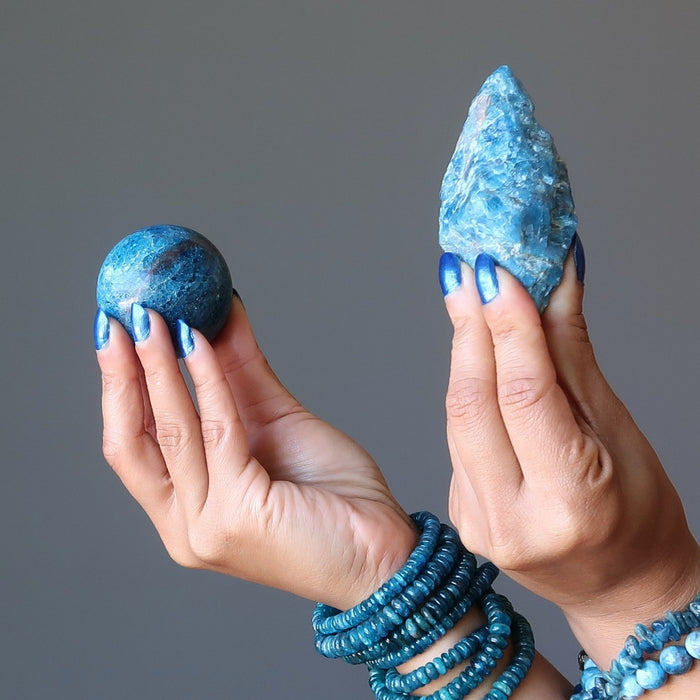 hands wearing apatite bracelets holding apatite stones