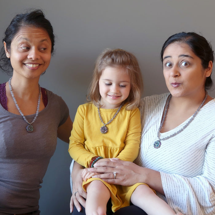 two sisters and niece wearing matching crystal healing necklaces