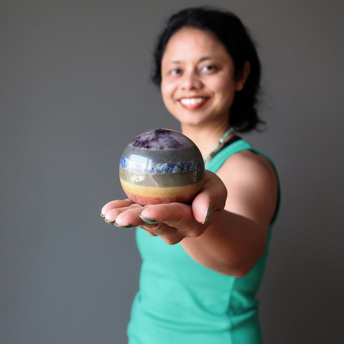 sheila of satin crystals holding out a 7 layered chakra crystal ball