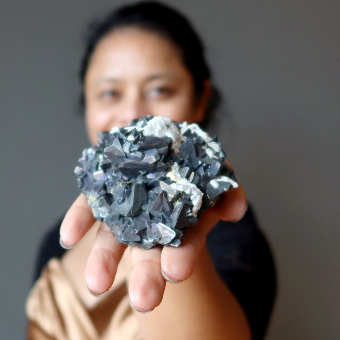 sheila of satin crystals holding out a crystal cluster
