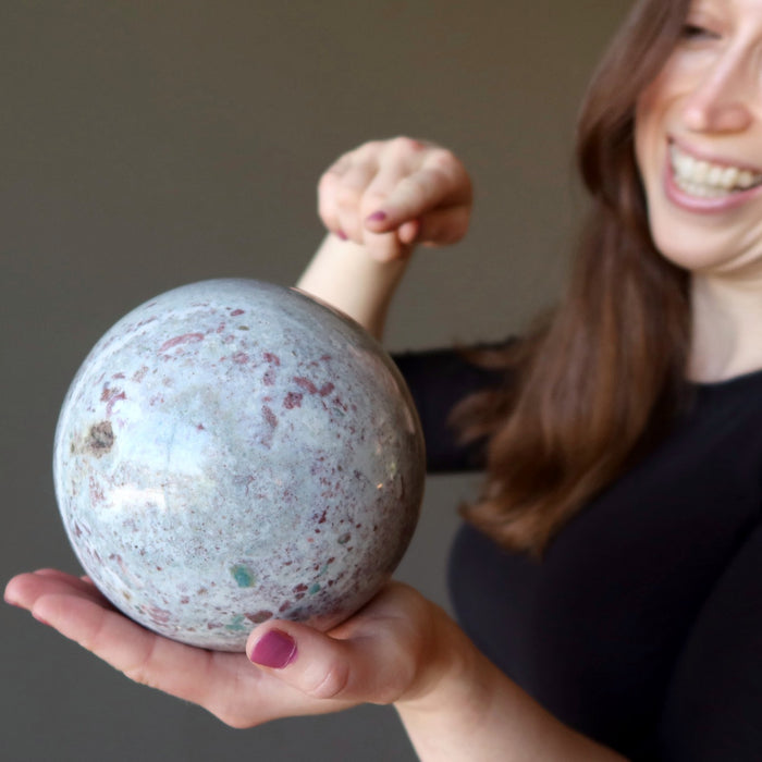 woman holding jasper sphere pointing