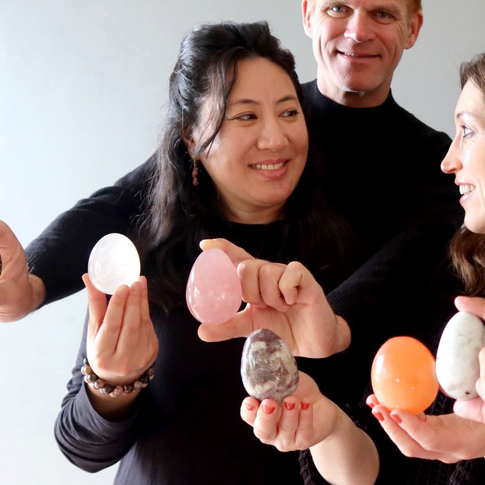 people holding crystals eggs