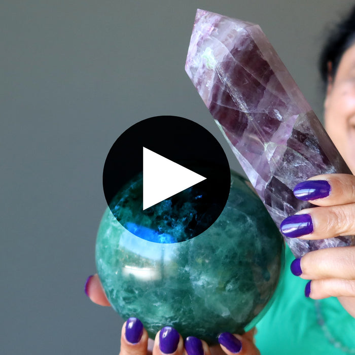 woman holding fluorite wand and sphere