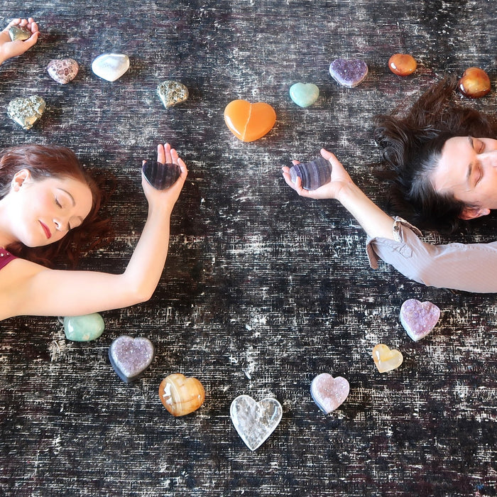 man and woman lying in a crystal heart grid