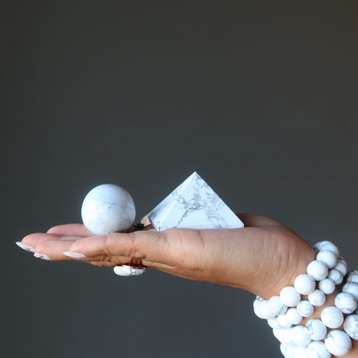 hand wearing and holding howlite stones