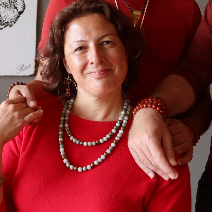woman wearing two jade necklaces and a jade bangle