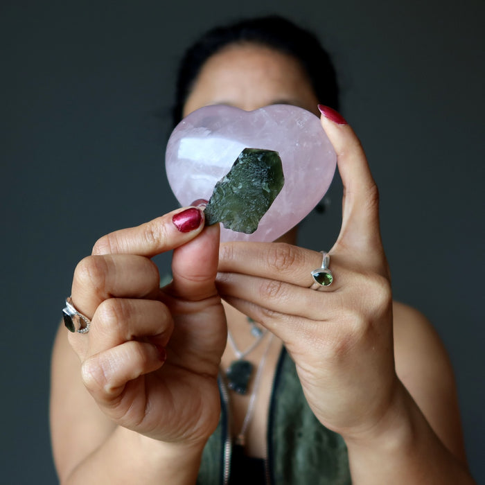 sheila of satin crystals holding pink rose quartz heart and rough  moldavite stone